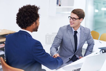 Photo for Welcome to the team. two businessmen shaking hands in an office - Royalty Free Image