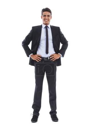 Photo for Hes business is standing strong. Portrait of a confident young businessman standing with hands on hips against a white background - Royalty Free Image