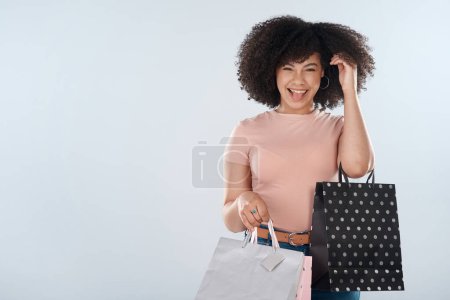 Photo for Portrait, mockup and woman with bags, shopping and confident girl on a grey studio background. Face, female person or customer with boutique products, items and fashion with discount clothes or sales. - Royalty Free Image