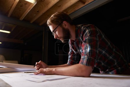 Photo for Hes an expert draftsman. a male architect drawing up building plans - Royalty Free Image