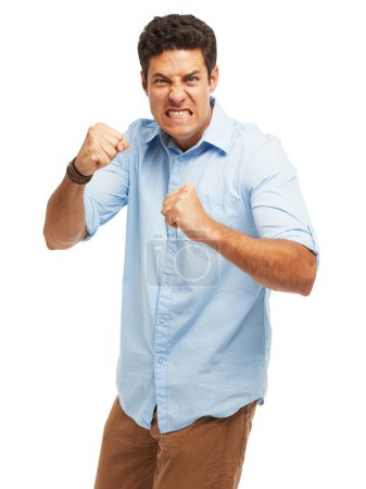 Photo for Furious and frustrated. An angry young man with fists clenched ready to punch against a white background - Royalty Free Image