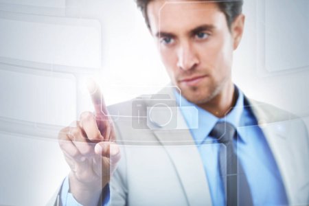 Photo for Business solutions in the digital age. Concept shot of a young businessman touching a digital interface - Royalty Free Image