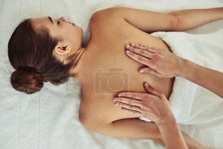 Photo for Relax, back and massage with woman in spa for wellness, luxury and cosmetics treatment from above. Skincare, peace and zen with female customer and hands of therapist for therapy, salon and detox. - Royalty Free Image