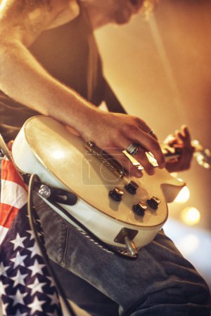 Photo for Guitar, hands and stage in closeup for rock concert, performance and singing at party, event and night. Male musician, artist or rockstar with instrument at music festival for art, sound and career. - Royalty Free Image