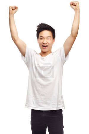 Photo for Yes, winning and portrait with a Asian male teen with youth and achievement in studio. Winner, excited and teenager with white background and victory win with a smile and happiness feeling success. - Royalty Free Image