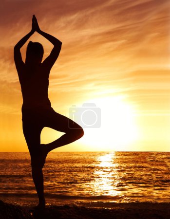 Photo for Silhouette, sunset and woman in tree pose with yoga on the beach, orange sky and fitness outdoor. Meditation, wellness and peace in nature with shadow, female yogi person and pilates by the ocean. - Royalty Free Image