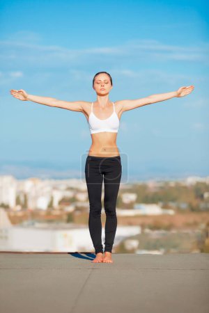 Photo for Calm woman, yoga and open arms on roof top in exercise, zen workout or fitness outdoors. Female yogi in warm up stretch or pose for healthy body, spiritual wellness or balanced mind outside town. - Royalty Free Image