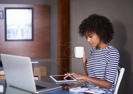Laptop, tablet and woman with coffee for work from home opportunity, freelancer career and multimedia planning. African person or remote worker drinking tea with inspiration for digital tech project. Poster 656520348