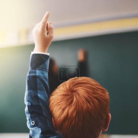 Photo for I have a question. elementary school children raising their hands to ask questions in the class - Royalty Free Image