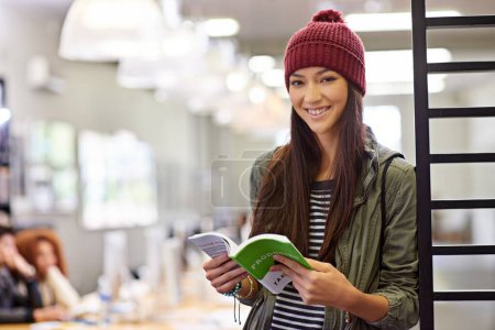 Photo for Woman with smile in portrait, student in library reading book and study for exam on university campus. Education, learning and academic development with female person holding textbook for knowledge. - Royalty Free Image