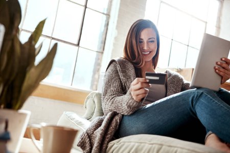 Photo for Smile, tablet and credit card, happy woman on couch in living room and internet banking or fintech in home. Technology, online shopping payment and girl on sofa surfing retail website or digital shop. - Royalty Free Image
