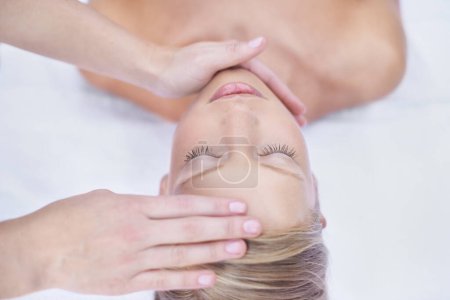 Photo for Relax, acupressure and facial massage, woman in beauty salon for health, wellness and luxury treatment with eyes closed. Spa, professional skin care therapist hands on healthy face of girl from above. - Royalty Free Image