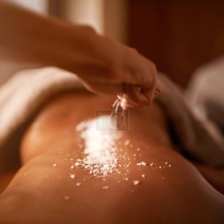 Photo for Spa, back and hands with salt massage of a woman with beauty specialist with treatment. Exfoliate, female person skincare and relax detox application for skin and calm wellbeing at a hotel with care. - Royalty Free Image