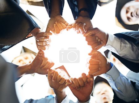 Photo for Together we can build a brighter future. Closeup shot of a group of students joining their hands together on graduation day - Royalty Free Image