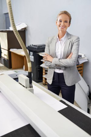 Photo for Whatever you need, we can print. A self-assured young publisher standing alongside a printing machine - Royalty Free Image