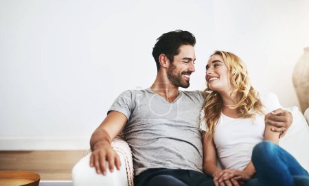 Photo for Smile, relax or happy couple hugging on house sofa bonding or smiling with trust or loyalty together. Smile, lovers or woman enjoys quality time with a romantic man on couch on weekend break at home. - Royalty Free Image