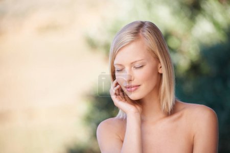 Photo for Hand, face and beauty of a woman outdoor in nature for natural makeup, dermatology and cosmetics. Female model person happy with green or sustainable skincare, facial self care and healthy skin glow. - Royalty Free Image