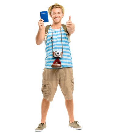 Photo for Lets travel. Full length shot of a young tourist standing in the studio and showing a thumbs up while holding his passport - Royalty Free Image