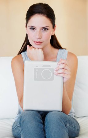 Photo for Digital tablet, portrait and woman relax on a sofa with social media, reading and browsing in her home. Face, subscription and female in living room, streaming and satisfied with online entertainment. - Royalty Free Image