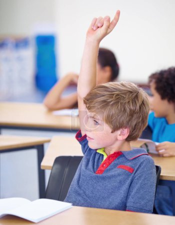 Photo for Classroom, child and raise hand for questions, support and help with education and teaching in school or classroom. Young boy or kid with arm up for knowledge, learning and class answer or advice. - Royalty Free Image