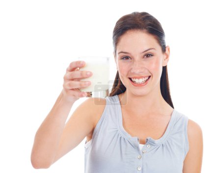 Téléchargez les photos : Portrait smile, woman and glass of milk for vitamin D healthcare benefits, bone health or nutritionist hydration drink. Calcium dairy product, wellness and studio model isolated on white background. - en image libre de droit