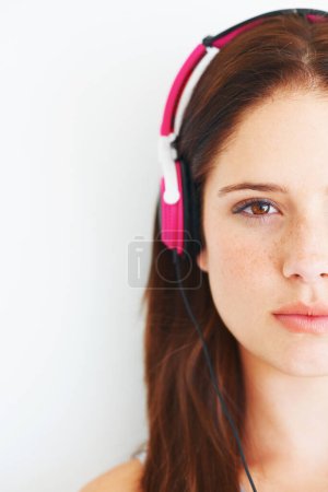 Photo for Music headphones, half face and woman portrait listening to calm girl song, wellness audio podcast or radio sound. Studio, freedom or gen z model streaming relax playlist isolated on white background. - Royalty Free Image