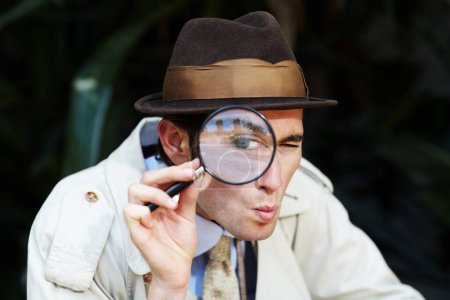 Private investigator, eye in magnifying glass and portrait of man for detective, searching and looking. Spy, investigation and male person with magnifier for secrets, information and mystery clue.