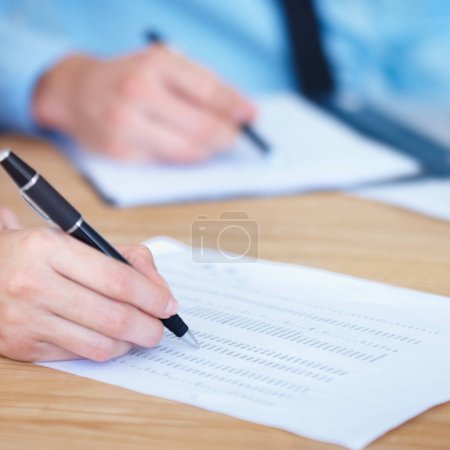 Photo for Business people, hands and writing on finance spreadsheet for accounting, budget or expenses on form. Hand of accountants working on financial report, documents or paperwork with pen on office desk. - Royalty Free Image