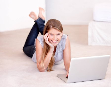 Photo for Laptop, relax and portrait of a woman on the floor browsing on social media, website blog or the internet. Happy, smile and female person laying on the ground with computer for entertainment at home - Royalty Free Image