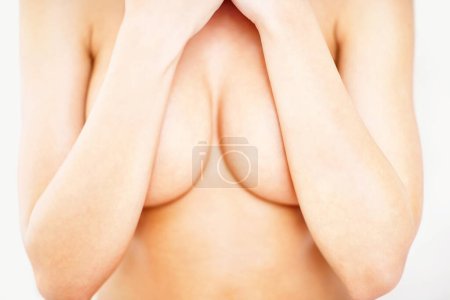 Photo for Cover, closeup and breast of woman in studio for sensual, cleavage and temptation. Nude, topless and chest with body of girl for attractive, flirting and desire isolated on white background. - Royalty Free Image