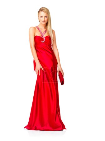 Téléchargez les photos : Young and elegant woman in a red dress or fancy gown while feeling confident and beautiful against a copy space background. Lady wearing designer clothes and accessories for prom, bridesmaid or event. - en image libre de droit