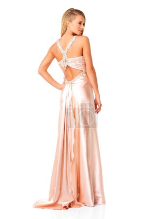 Téléchargez les photos : Fashion, glamour and elegant while wearing a dress or evening gown as a wedding bridesmaid or for prom against white studio background. Classy and beautiful young woman attending fancy party or event. - en image libre de droit