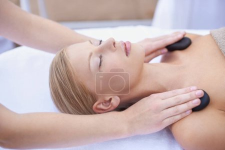 Photo for Woman getting hot stone massage, hands of masseuse in spa and healing holistic treatment with zen at wellness resort. Rocks on shoulders, peace with therapy, alternative medicine and self care. - Royalty Free Image