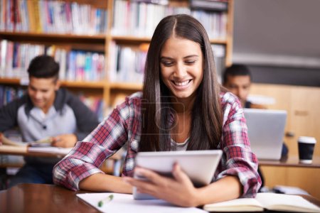 Photo for University, tablet and woman in school library for online research, studying and learning. Education, college academy and happy female student on digital tech for knowledge, internet and website. - Royalty Free Image
