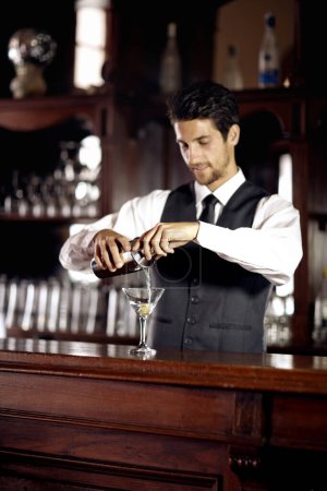 Photo for Bartender man, glass and mixing cocktail at bar for service, drink or hospitality at party, club or event. Male server, barman or waiter with alcohol, spirit or mixer for presentation at restaurant. - Royalty Free Image