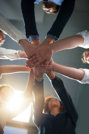 Photo for Hands together, solidarity and business people in team with low angle, support and trust with professional community. Diversity, collaboration and corporate group in meeting with goals and commitment. - Royalty Free Image