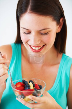 Photo for Happy woman, food and eating a healthy fruit salad with berries, nutrition and health benefits. Face of a female person on nutritionist diet with vegan meal for weight loss, wellness or detox. - Royalty Free Image
