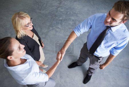 Photo for Top view, handshake and happy business people in deal, thank you and partnership agreement. Teamwork, networking and shaking hands in collaboration, welcome and support of promotion, trust or success. - Royalty Free Image