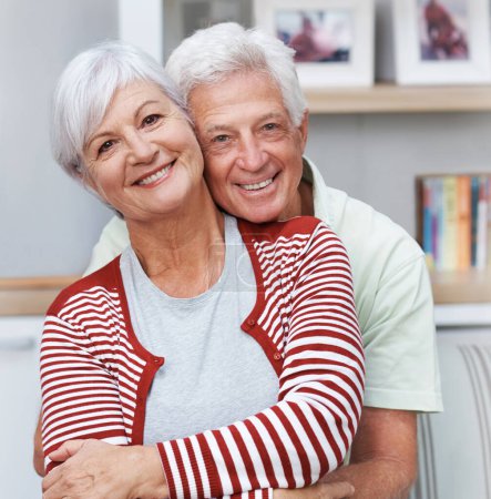 Photo for Senior couple, portrait and face with smile, love and care together for quality time at home. Happy elderly man, old woman and embrace in hug for relax retirement, loyalty and support of happiness. - Royalty Free Image