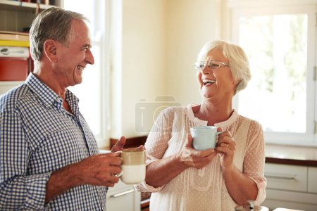 Photo for Funny, coffee or old couple laughing in kitchen at home bonding or enjoying quality time together. Happy retirement, morning or senior man talking, relaxing or drinking tea espresso with mature woman. - Royalty Free Image