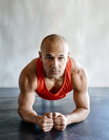 Photo for Gym floor, portrait and fitness man focus on plank exercise, health motivation or core strength building for bodybuilding. Training, hard work commitment and person doing muscle development workout. - Royalty Free Image