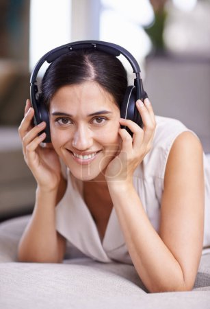 Photo for Happy woman, portrait smile and headphones for music listening, free time or relaxing on sofa at home. Face of female smiling in happiness on living room couch with headset for audio sound track. - Royalty Free Image