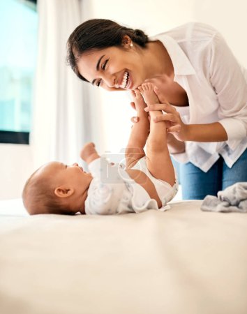 Photo for Happy, love and a mama with her baby in the bedroom of their home together for playful bonding. Family, children and a young mother spending time with her newborn infant on the bed for fun or joy. - Royalty Free Image