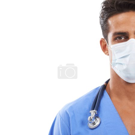 Photo for Hes a skilled surgeon. Portrait of a surgeon wearing a surgical mask and a stethoscope around his neck against a white background - Royalty Free Image