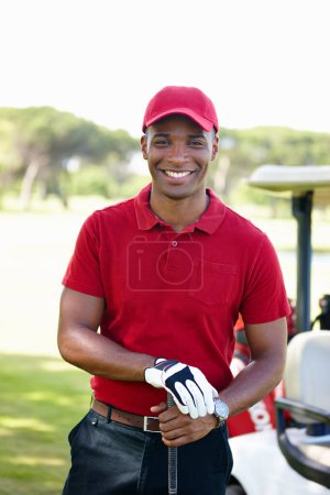 Photo for Having a great day out. Portrait of a happy young man standing on a golf course - Royalty Free Image