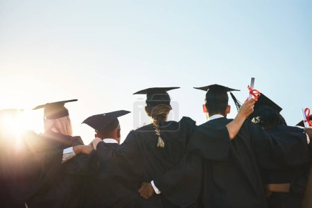 Photo for Group, students and graduation for college or university friends together with blue sky mockup. Men and women outdoor to celebrate education achievement, success and future at event for graduates. - Royalty Free Image