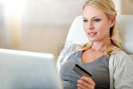 Photo for Woman, laptop and credit card for ecommerce, payment or electronic purchase in living room at home. Female person or shopper on computer for online shopping, bank app or internet banking at the house. - Royalty Free Image