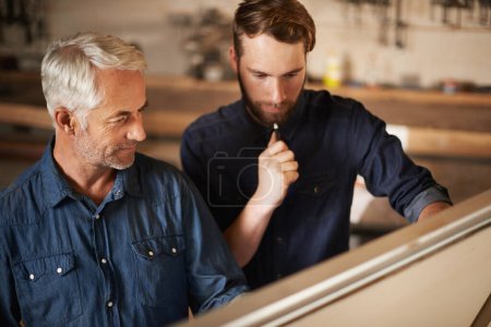 Photo for Adding up their brain power. a father and son working on a building project - Royalty Free Image
