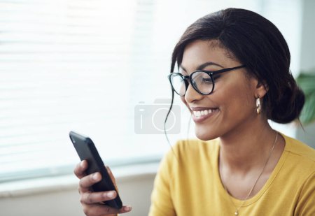 Photo for Phone, typing and happy woman reading online, social media post or networking on internet for job search. Creative, communication and african person in glasses, texting on mobile app or chat at home. - Royalty Free Image