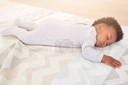 Photo for Bedroom, cute and baby sleeping in home on blanket for rest, nap time and dreaming in nursery. Childcare, newborn and cute, tired and African child in bed sleep for comfortable, relaxing and calm. - Royalty Free Image